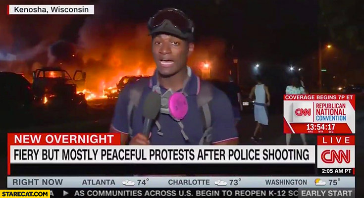 Fiery but mostly peaceful protest after police shooting fire burning in background tv reporter