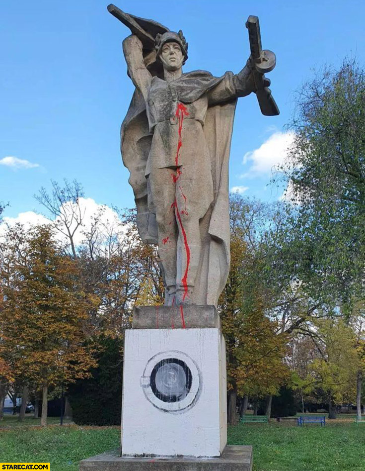 Russian soldier statue monument painted so that he’s standing on a washing machine